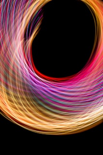 A dynamic 3D swirl of light trails against a deep blue backdrop