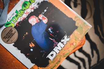 A vinyl album cover featuring a performer with a microphone against a dark background. The text includes 'Smoke Out' in large, colorful letters with additional branding, and the artist's name 'DMX' prominently displayed.