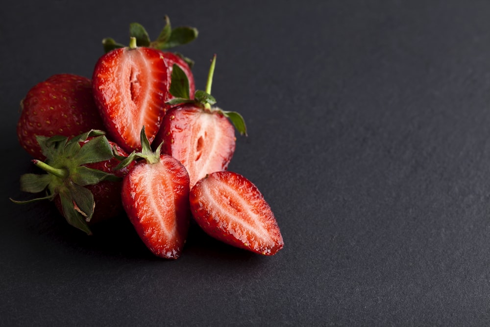 red strawberries on black textile