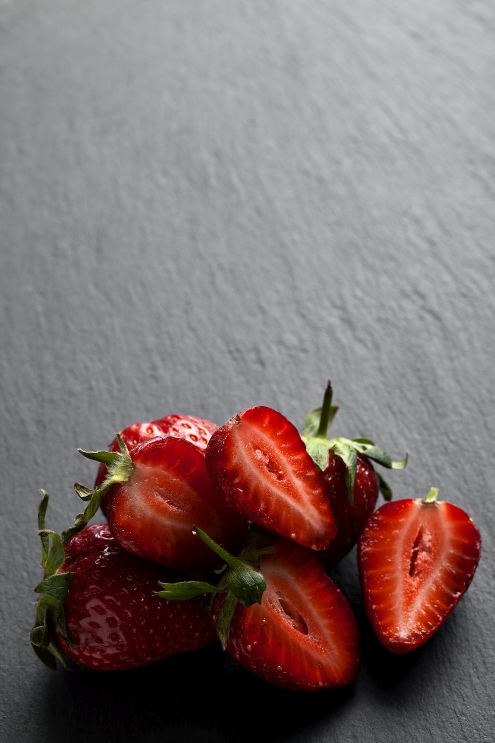 red strawberries on white textile