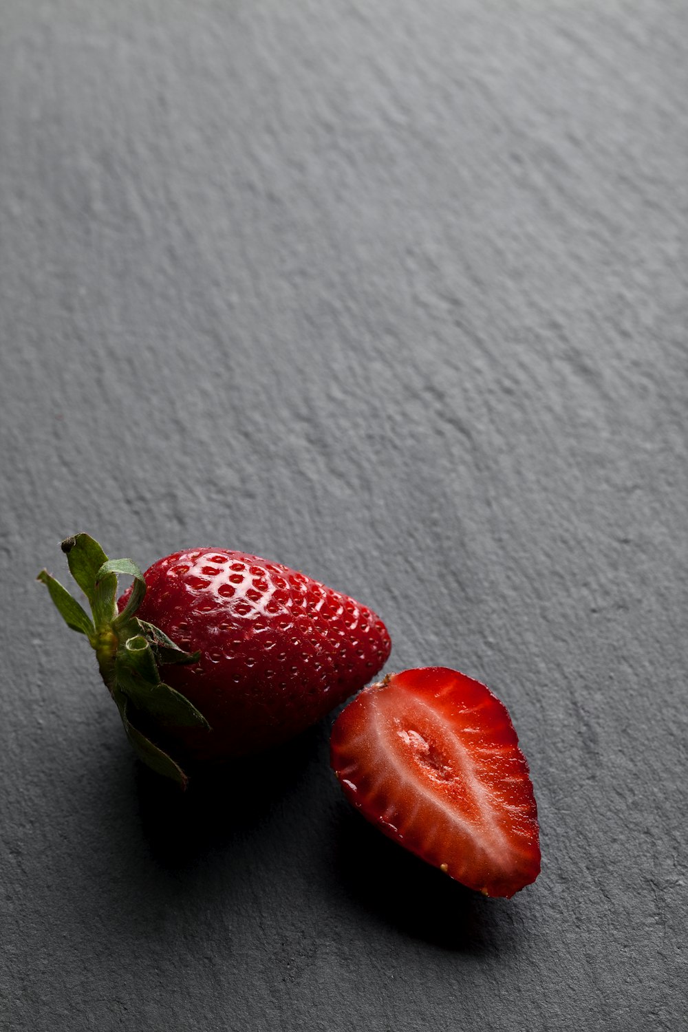 red strawberry on white textile