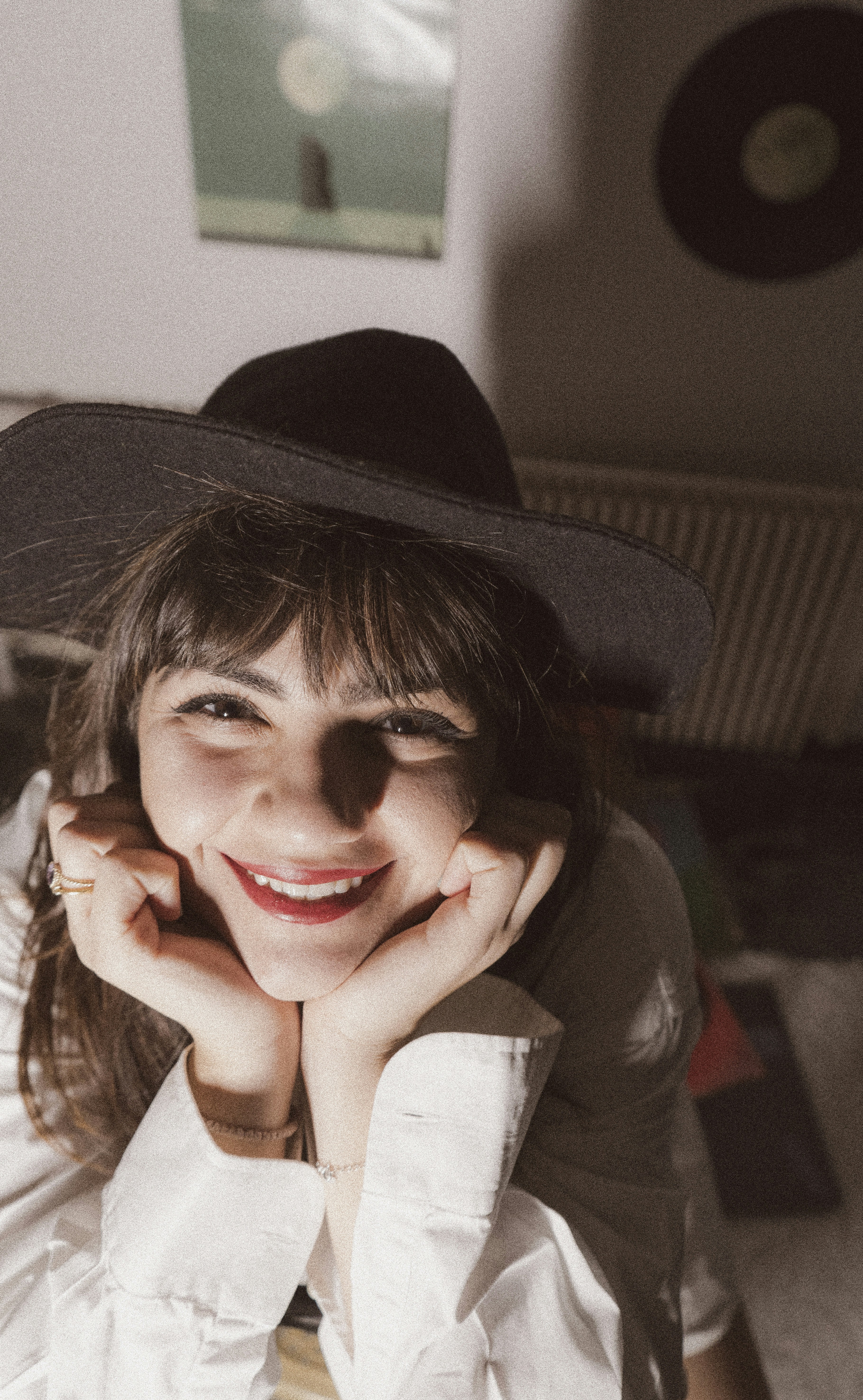 woman in black hat and gray and white plaid shirt