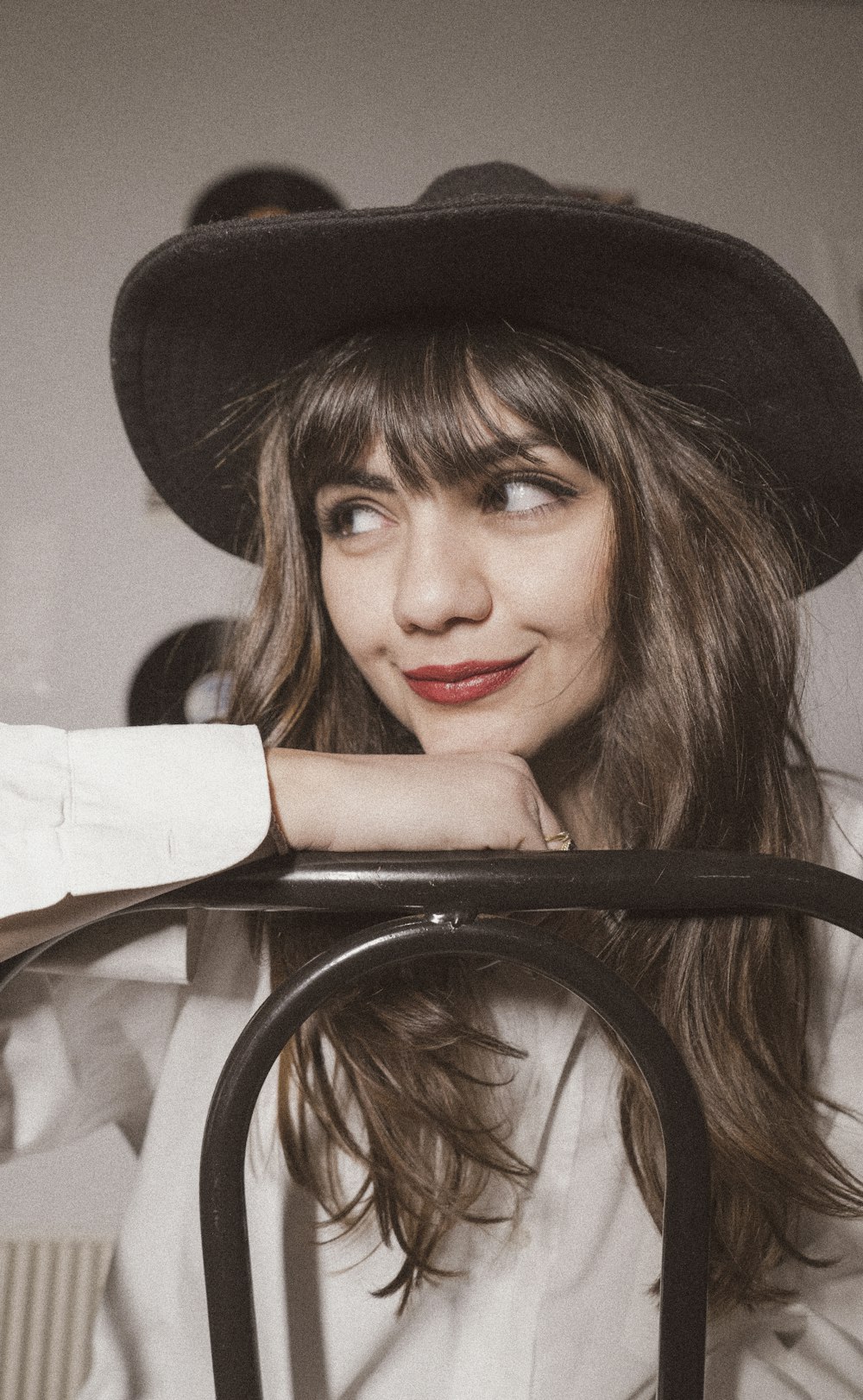 woman in black hat and white dress shirt