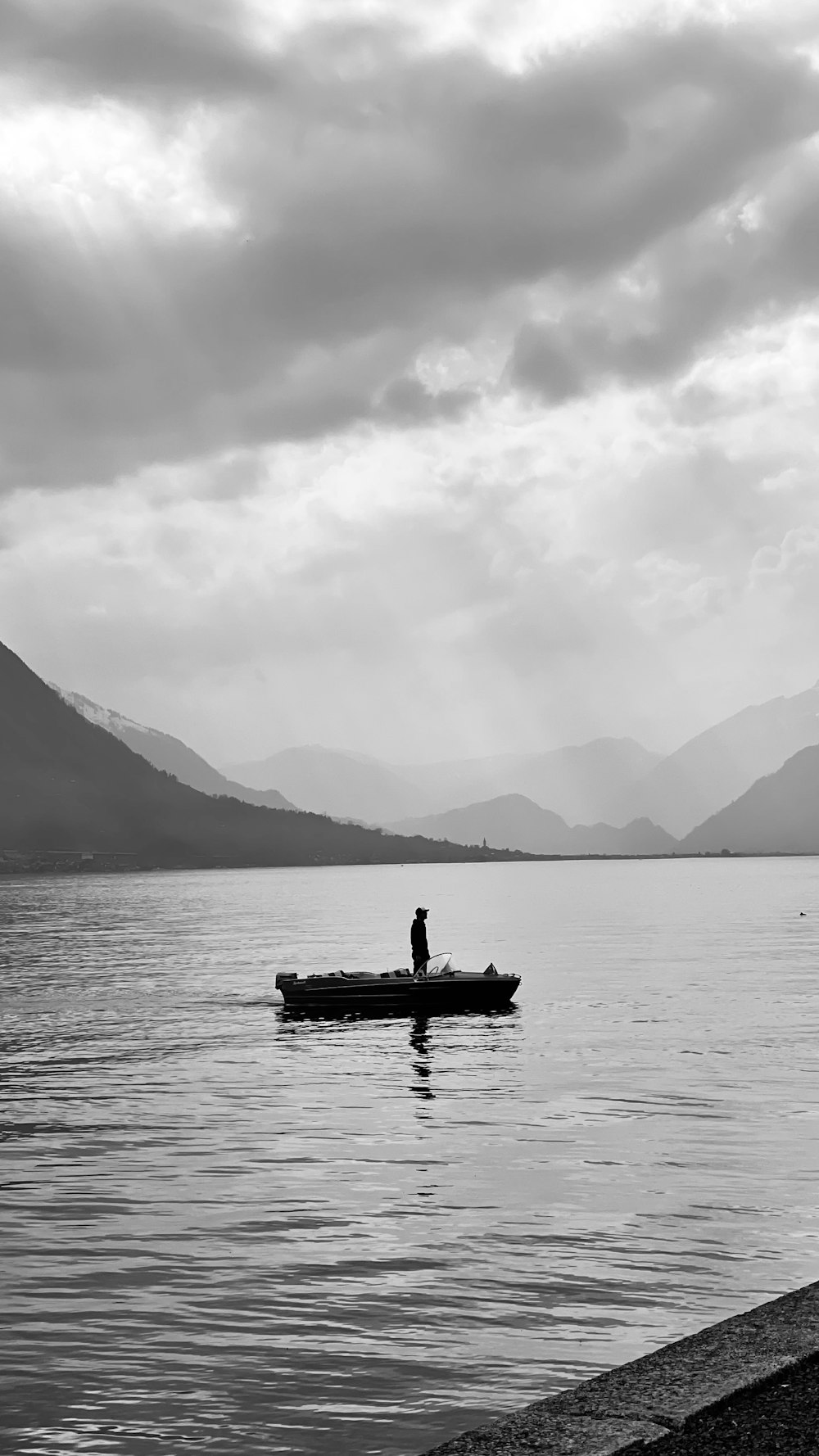 grayscale photo of 2 person riding on boat on body of water
