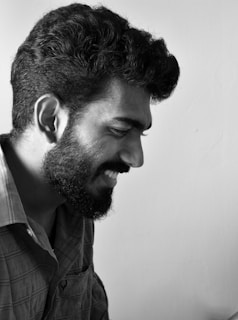 a black and white photo of a man with a beard