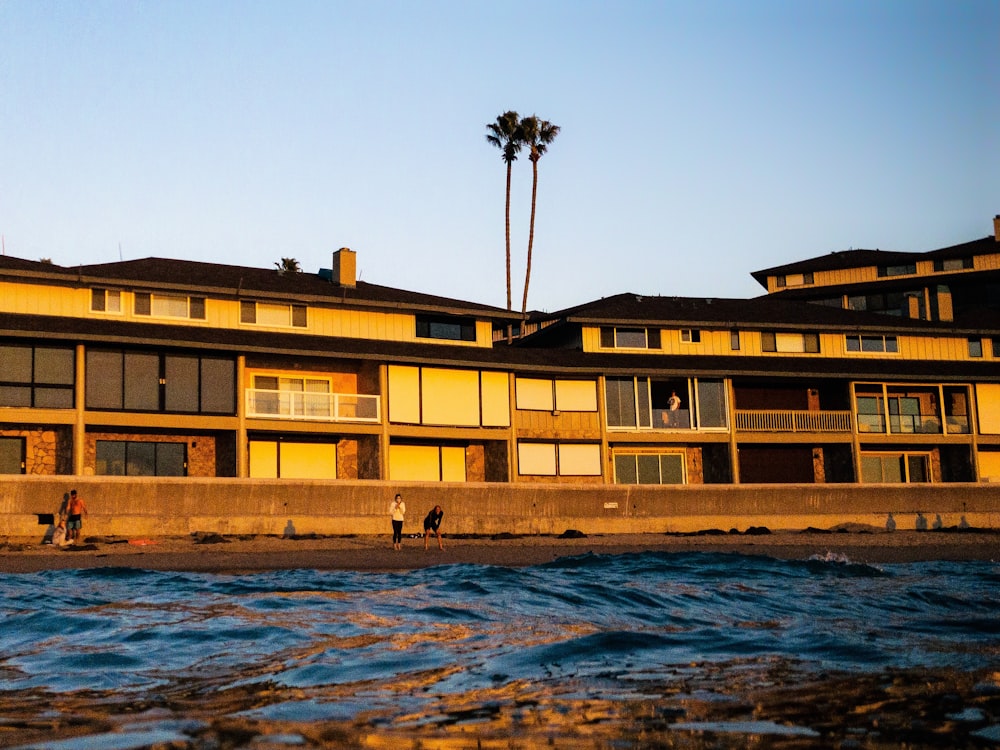 brown concrete building near body of water during daytime