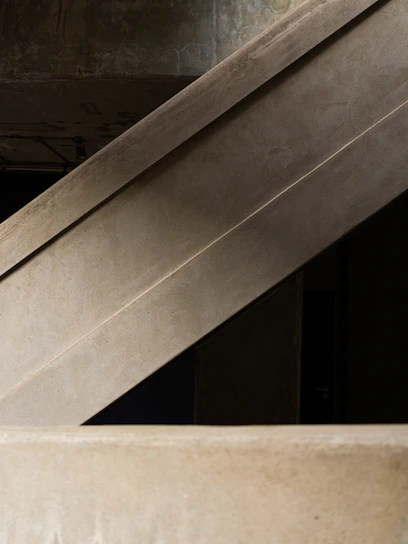 Concrete architectural structures with geometric lines and a modern aesthetic.