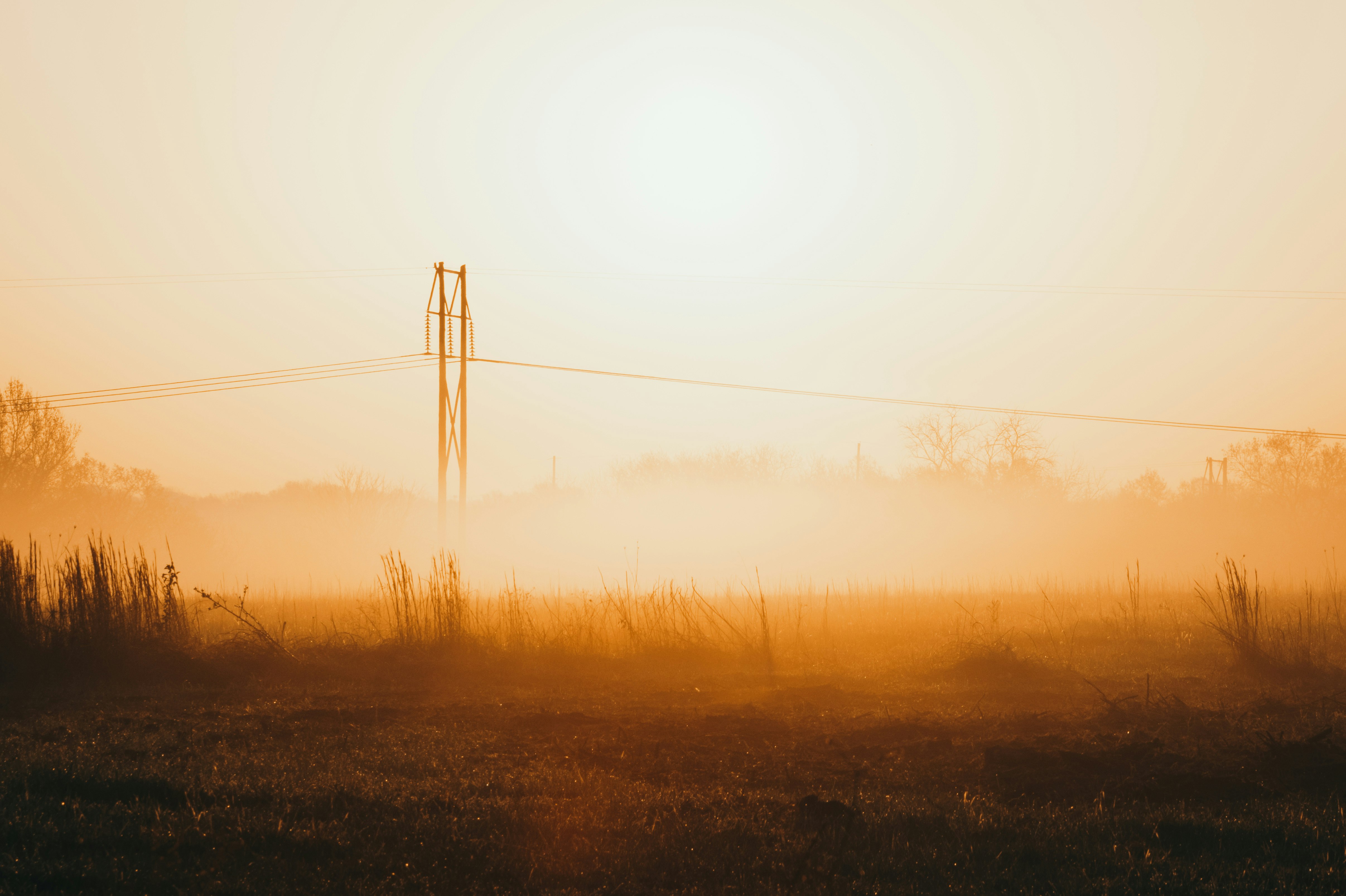 black electric post during sunset