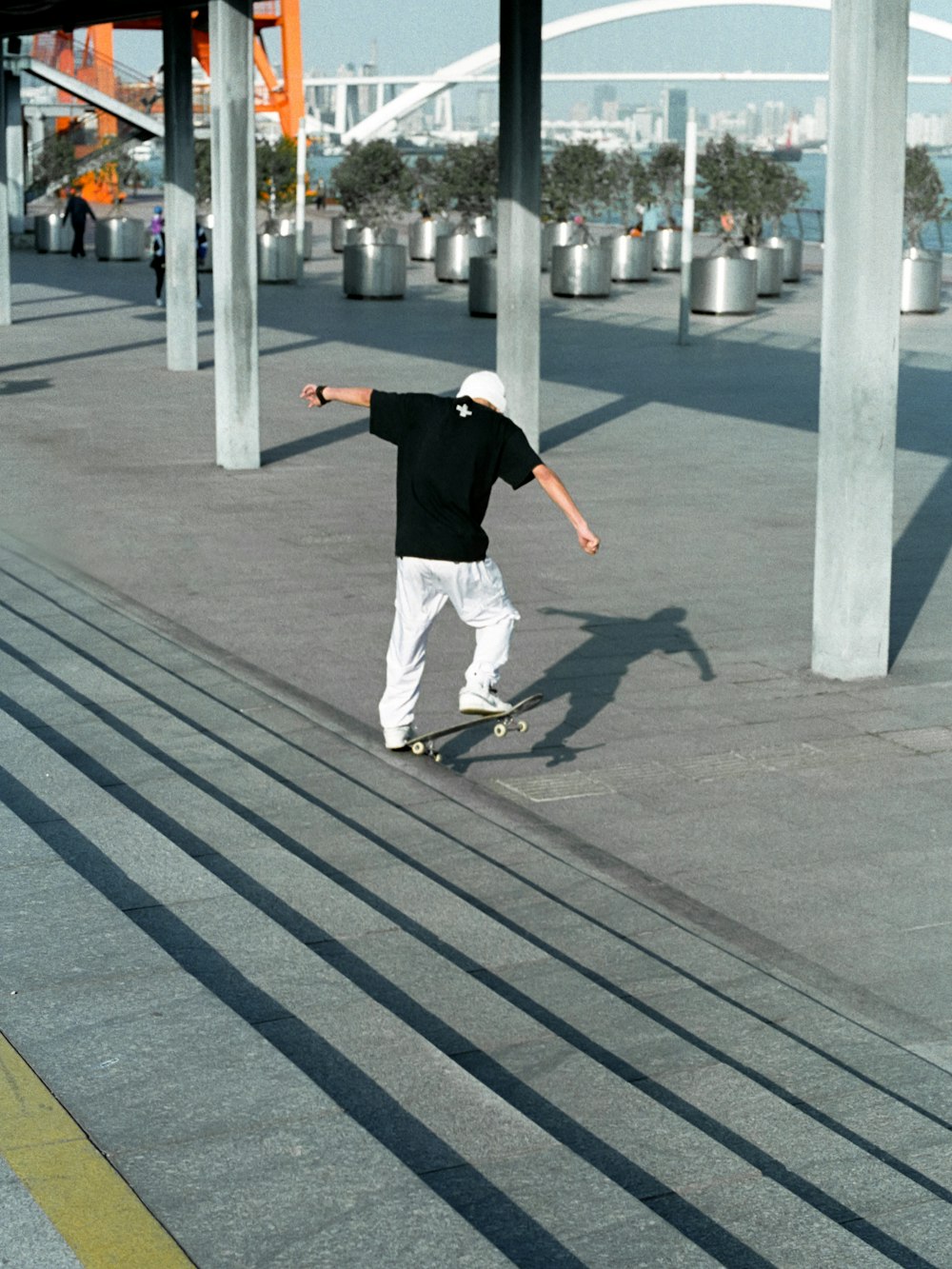 man in black t-shirt and white pants playing basketball during daytime