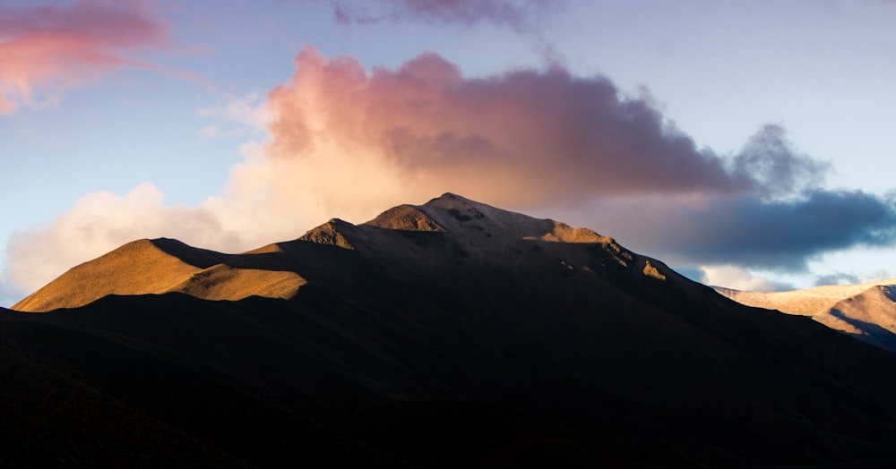 black and white mountain under white clouds