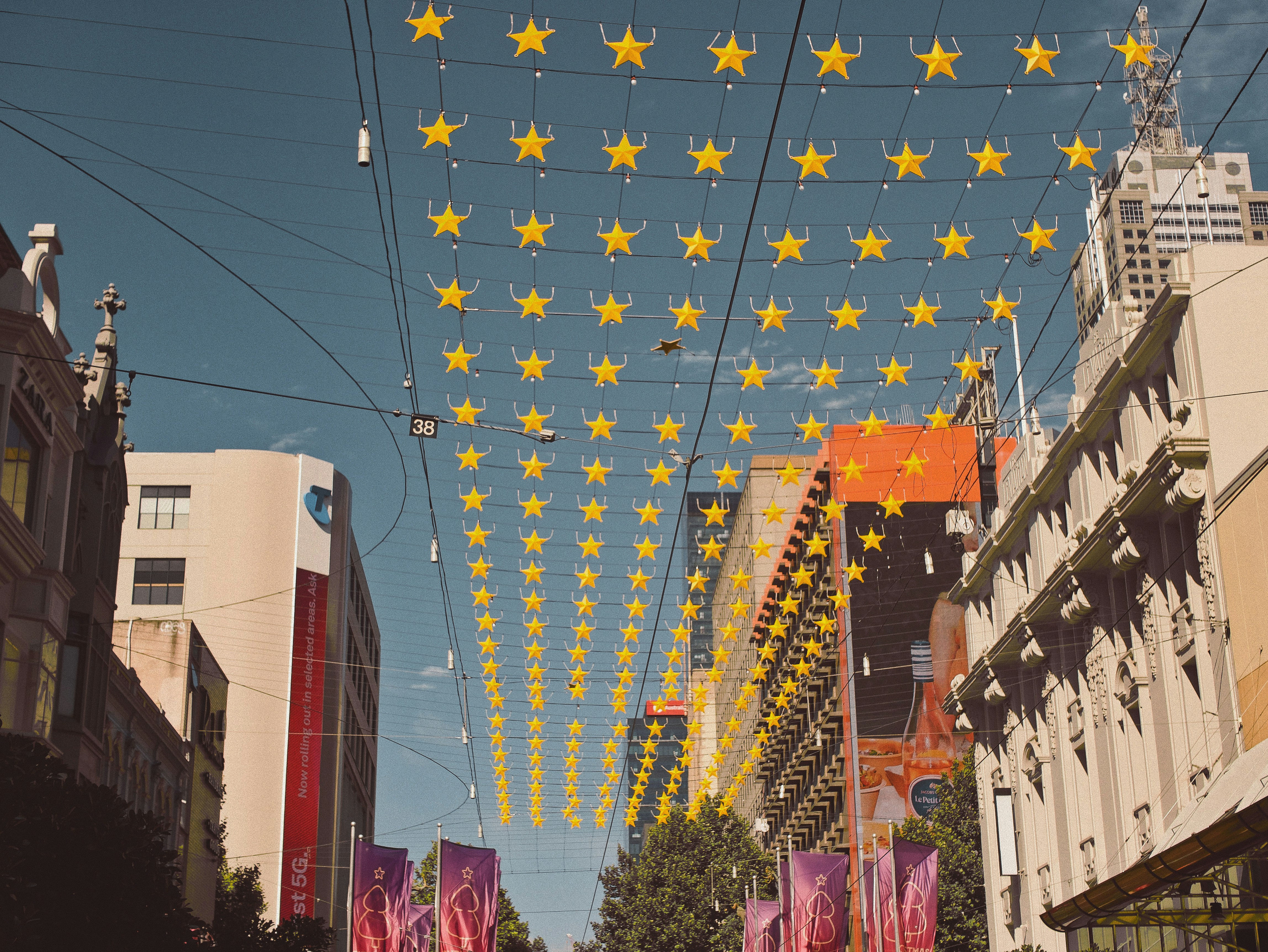 Strings of star-shaped lights hung over a city street