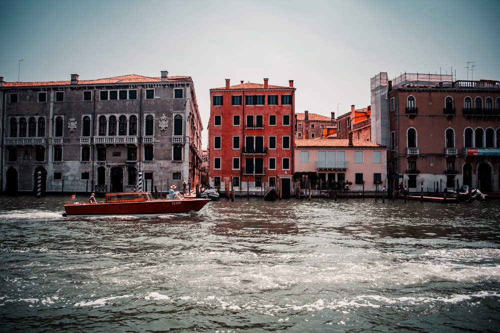 red and brown concrete building beside body of water during daytime