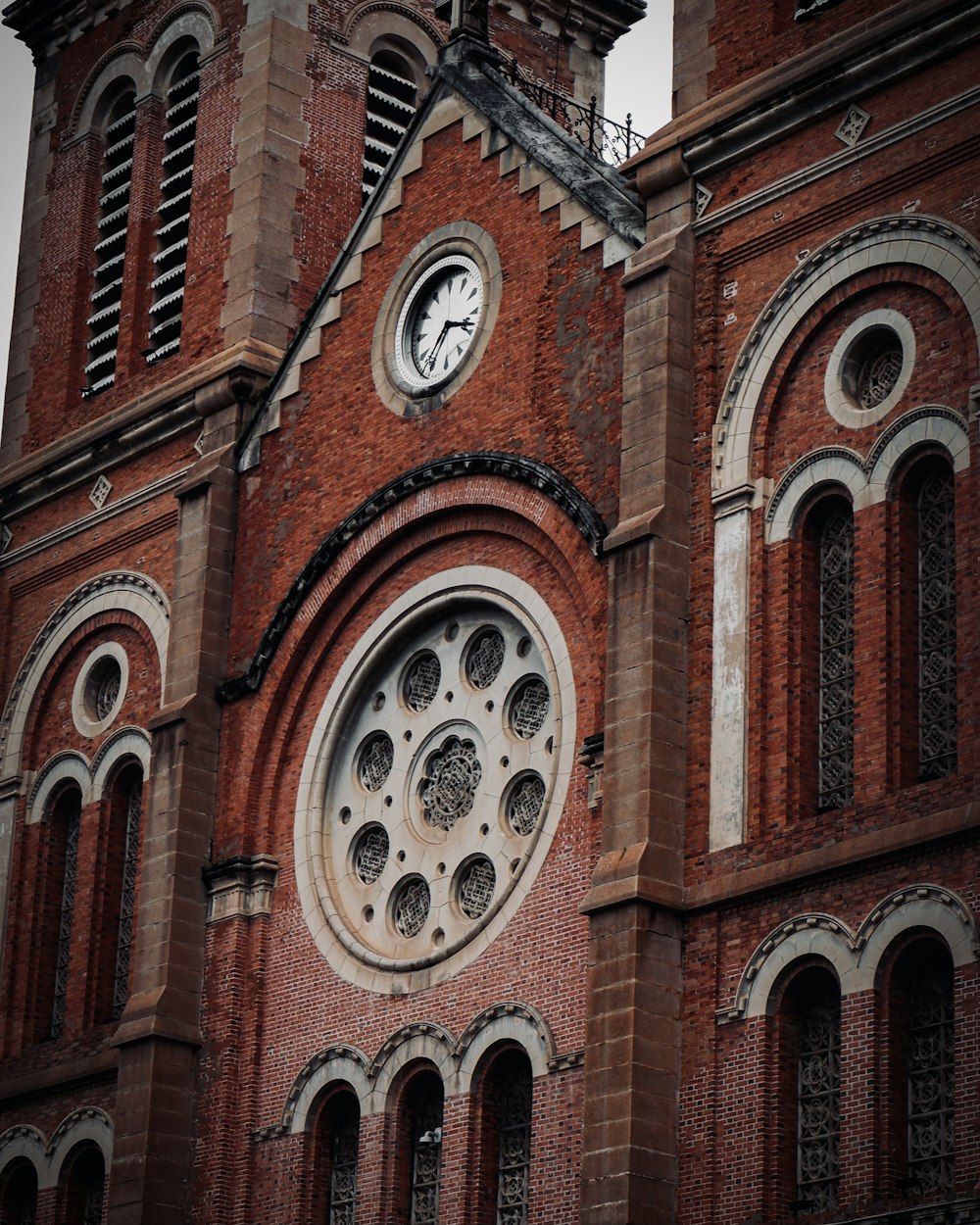 brown brick building with analog clock