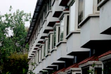 Close-up of modern factory buildings with clean lines and green spaces between structures.