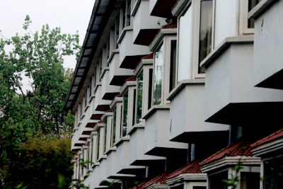 Close-up of modern factory buildings with clean lines and green spaces between structures.