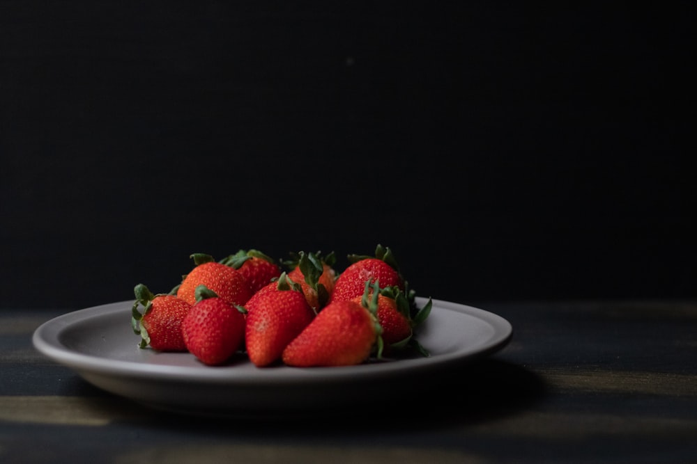 strawberries on white ceramic plate