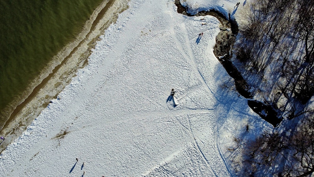 person walking on snow covered ground during daytime
