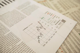 financial newspaper with stock chart