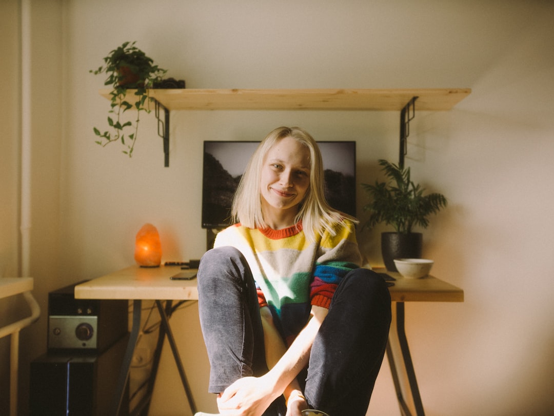 woman in blue denim jacket sitting on chair