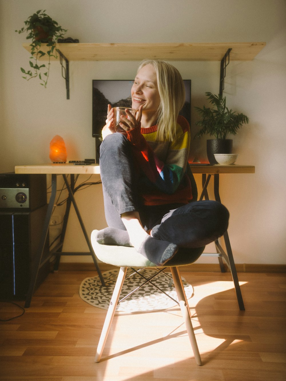 woman in black sweater sitting on white chair