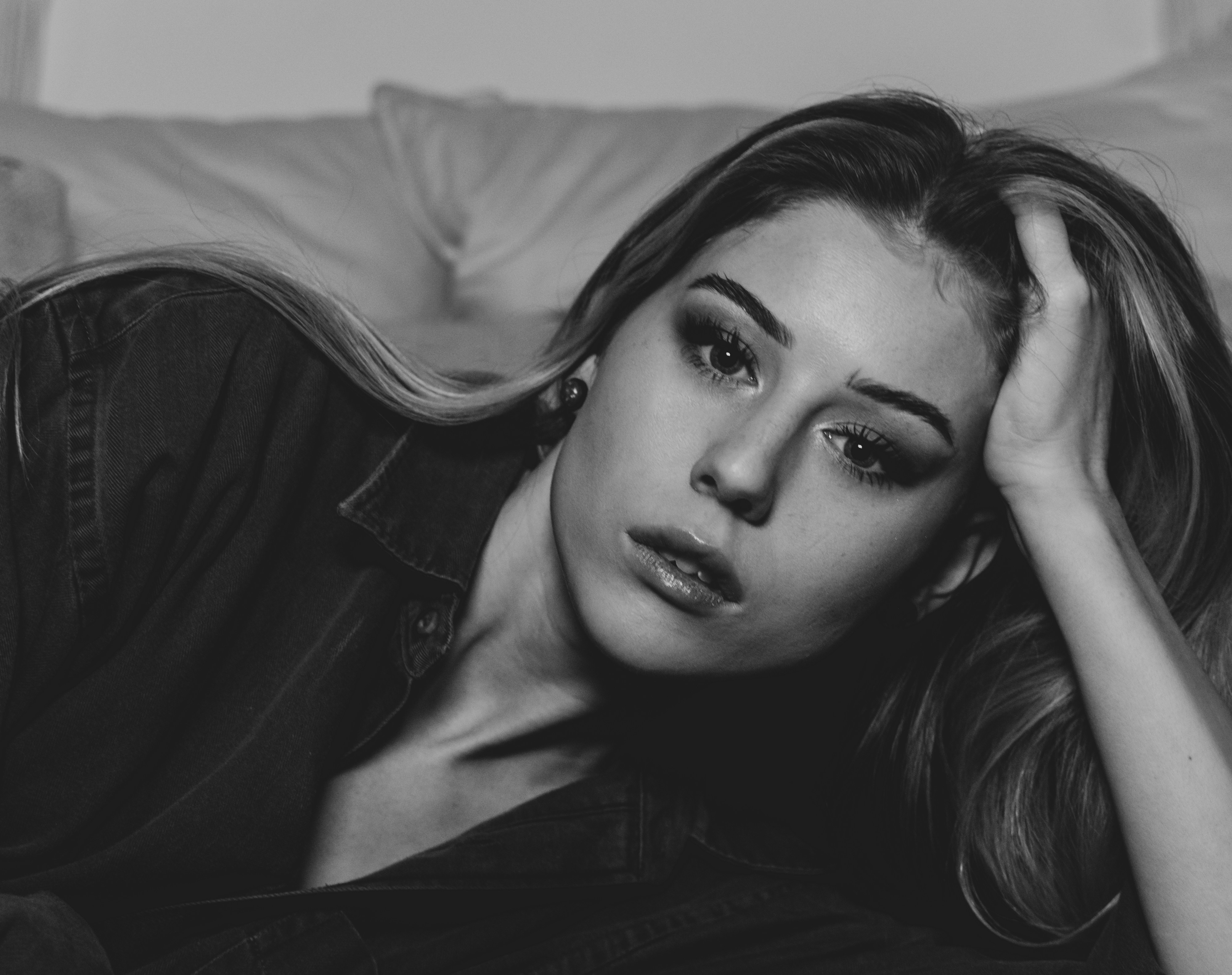 Woman in black shirt lying on bed