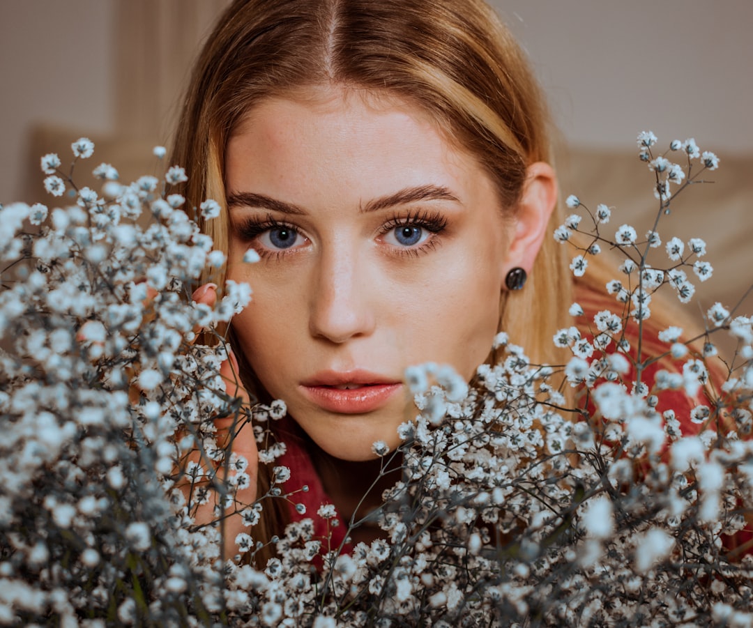 woman in red lipstick and white flower