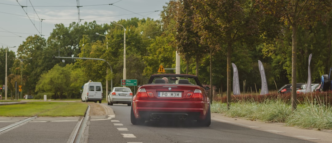 red car on road during daytime