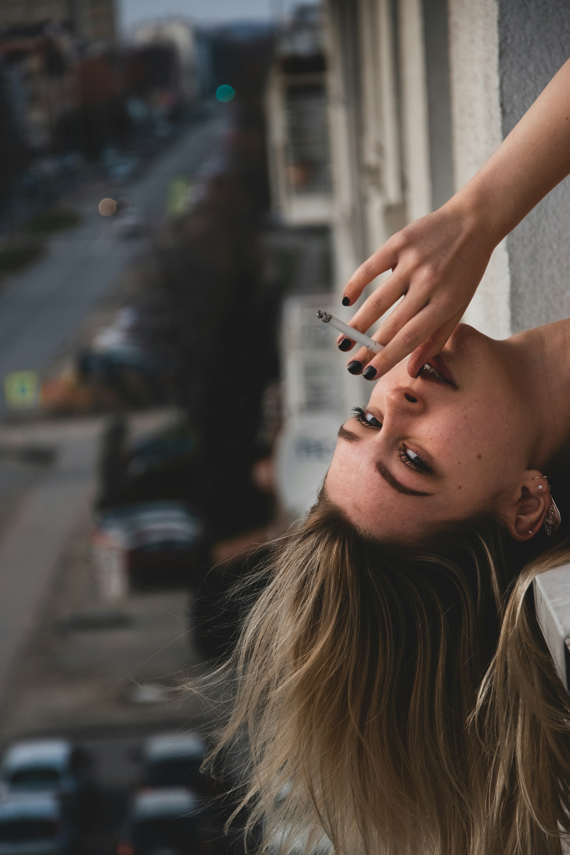 woman in white shirt holding her hair