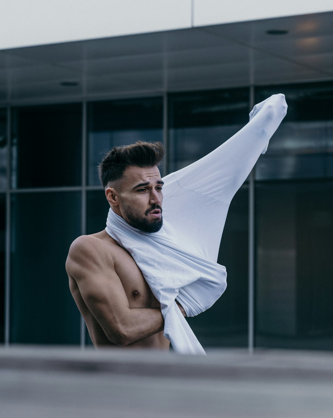 topless man holding white textile