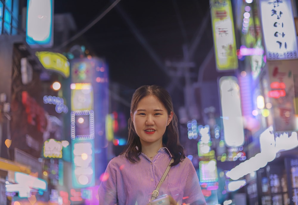 woman in pink and white floral shirt smiling