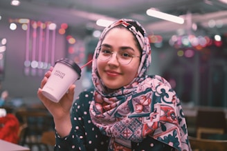 A cheerful mom sipping coffee while shopping with her kids.