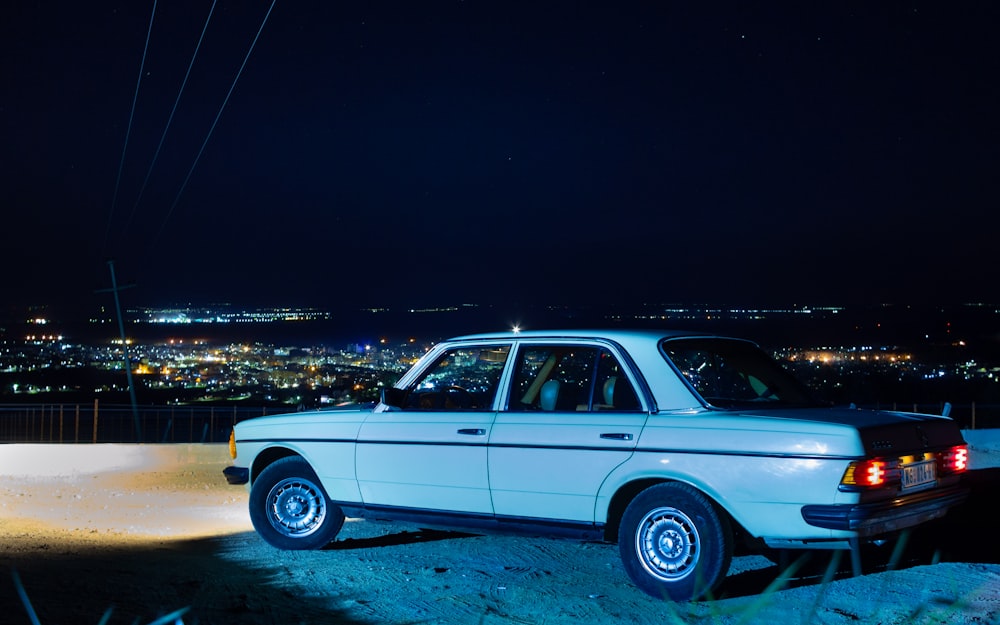 white station wagon on white sand during night time