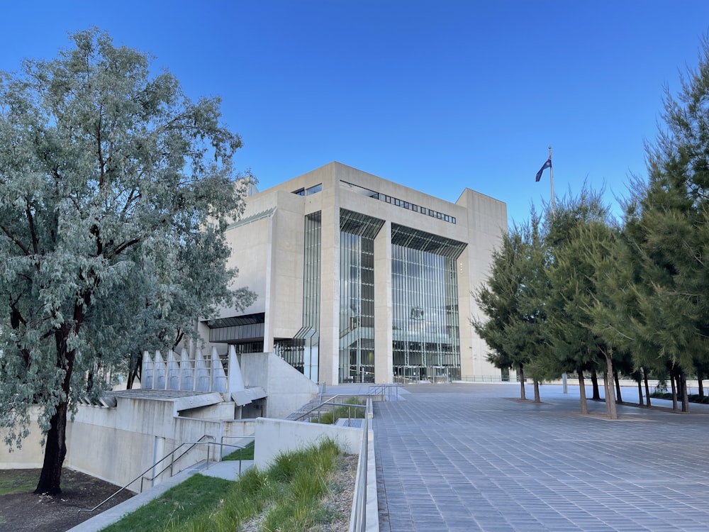 white concrete building near green trees during daytime