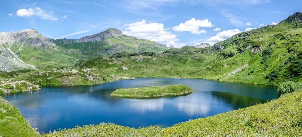 green grass field and lake