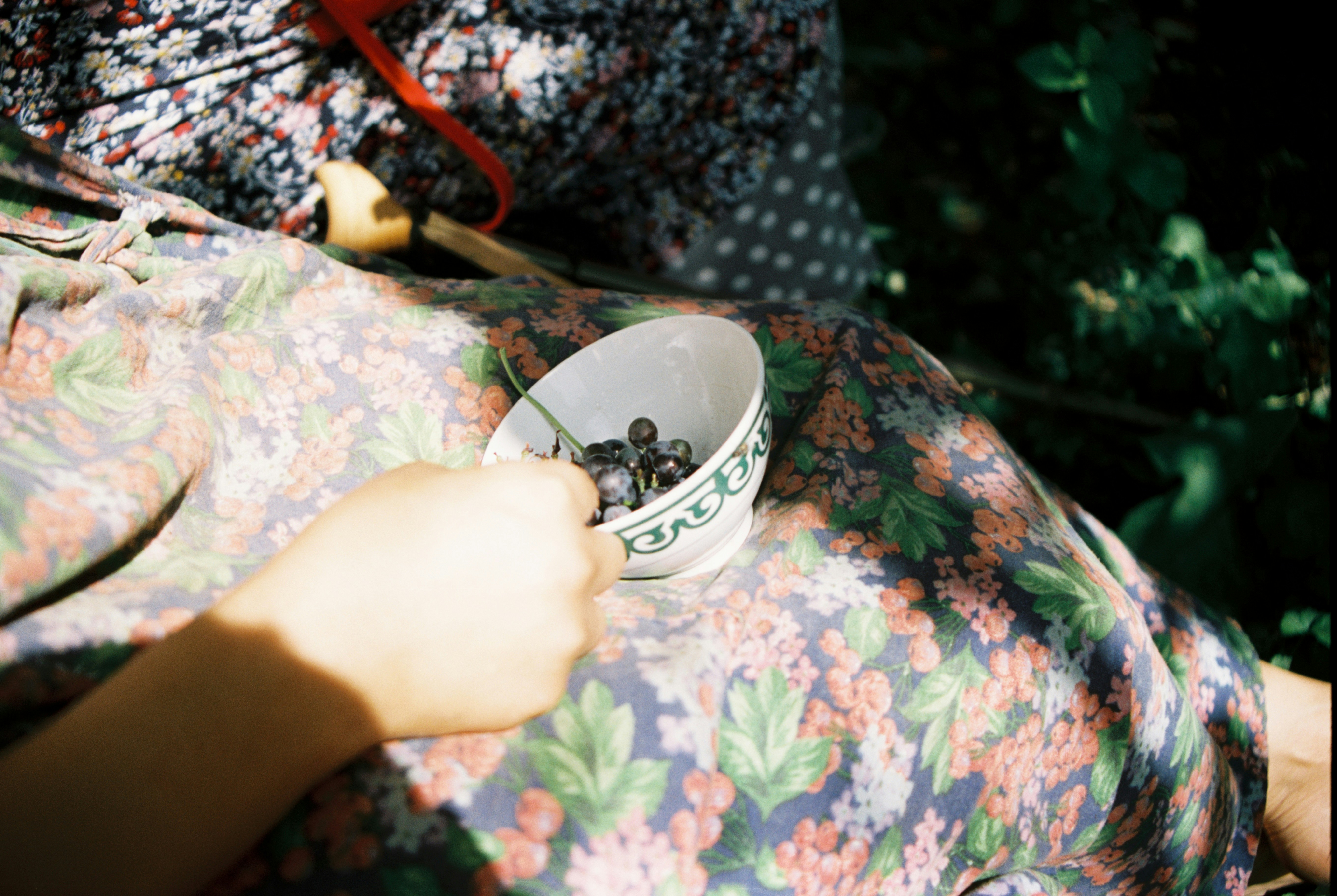 person holding white ceramic mug with saucer