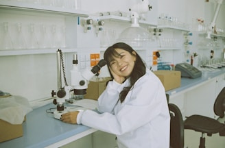 woman in white laboratory gown holding black microphone