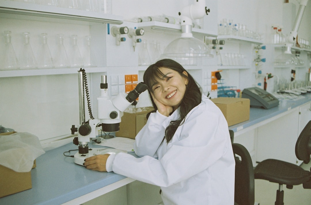 A student smiling at the lab desk