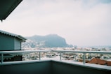 A scenic mountain view from a hotel balcony at sunset.