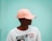 man in white crew neck t-shirt wearing orange cap
