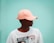 man in white crew neck t-shirt wearing orange cap