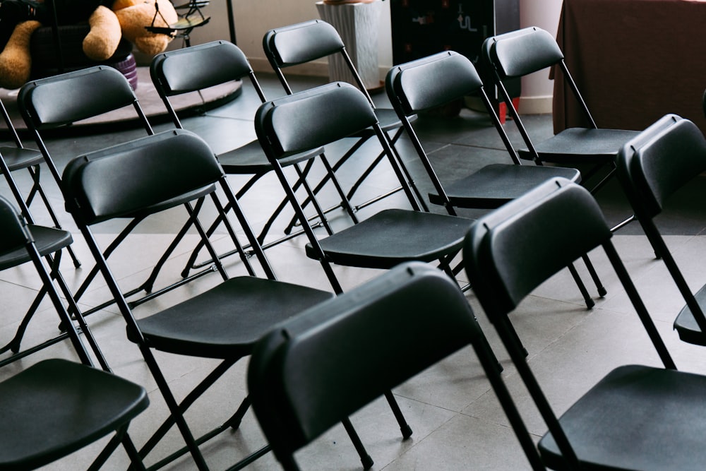 black metal framed black padded chairs