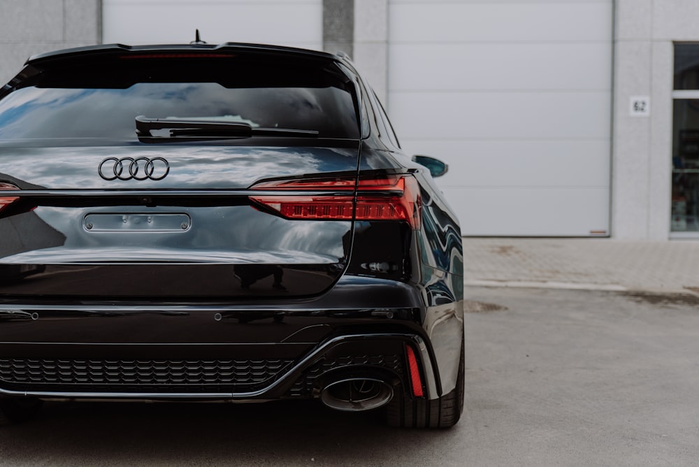 black bmw m 3 parked on gray concrete floor during daytime