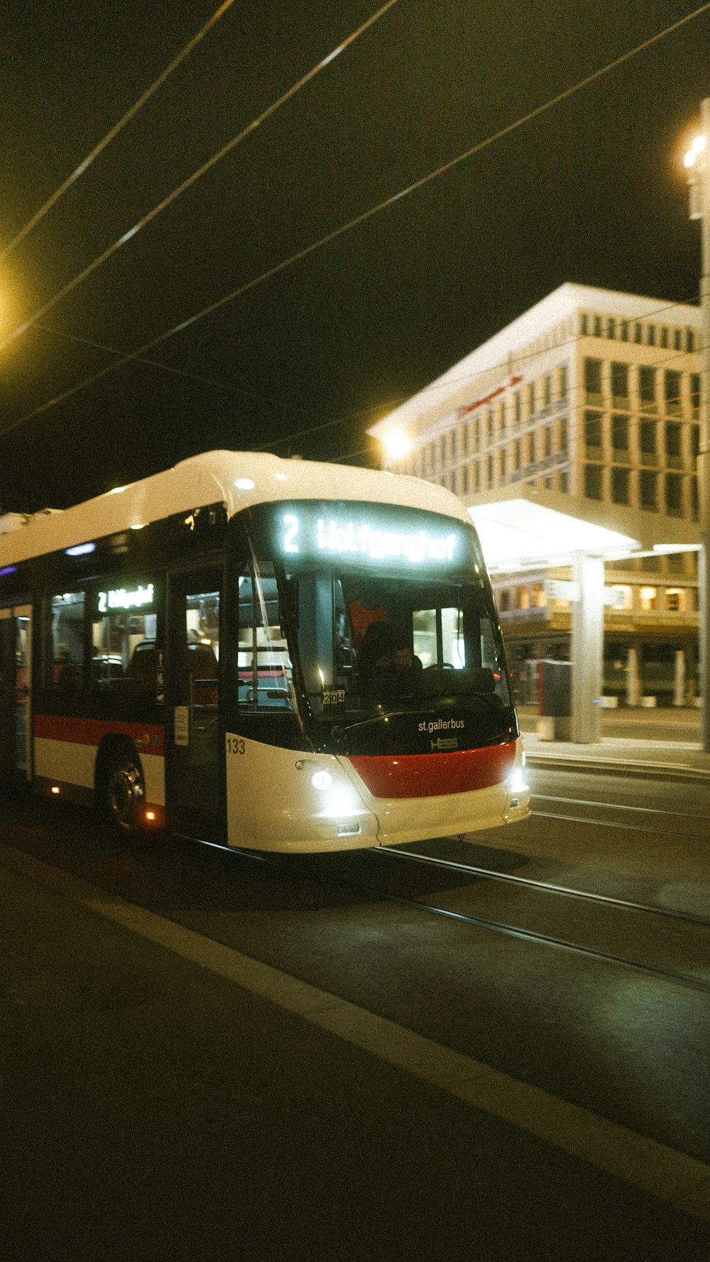 red and white bus on road during daytime