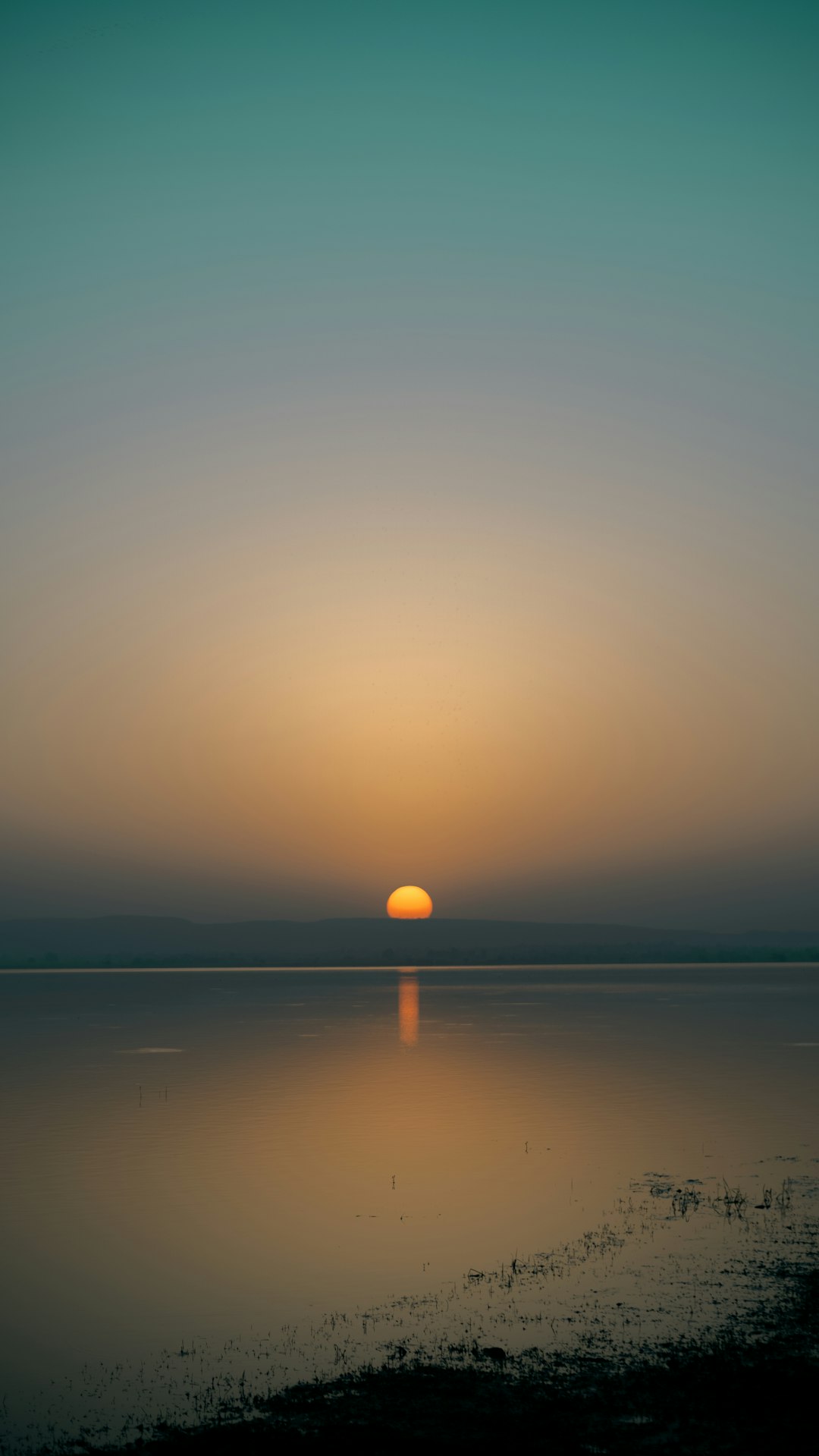 Calm sunrise over still water symbolizing hope and the gradual timeline of recovery from betrayal trauma