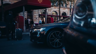 blue car parked near red building