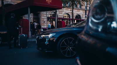 blue car parked near red building