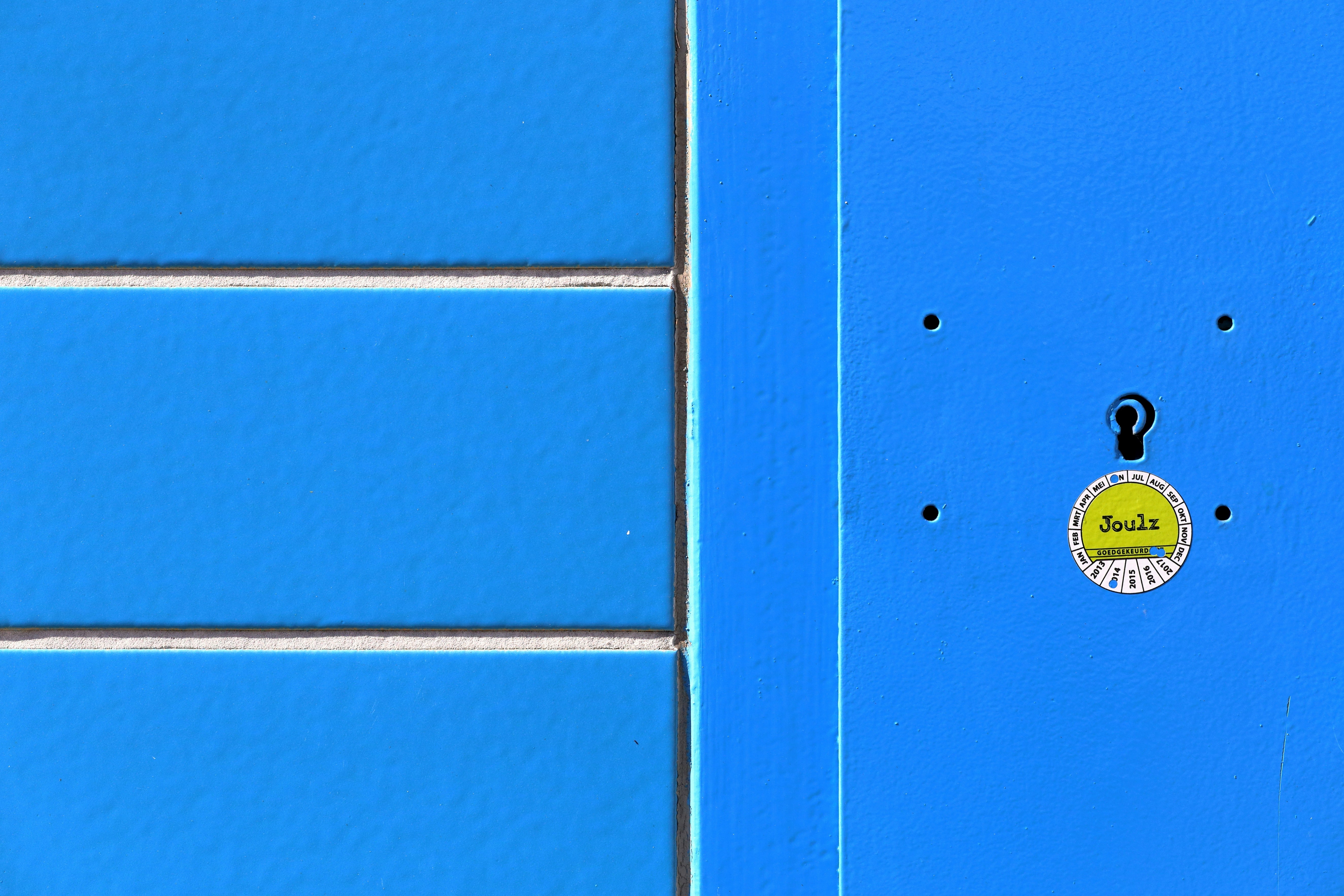 blue wooden door with gold door knob