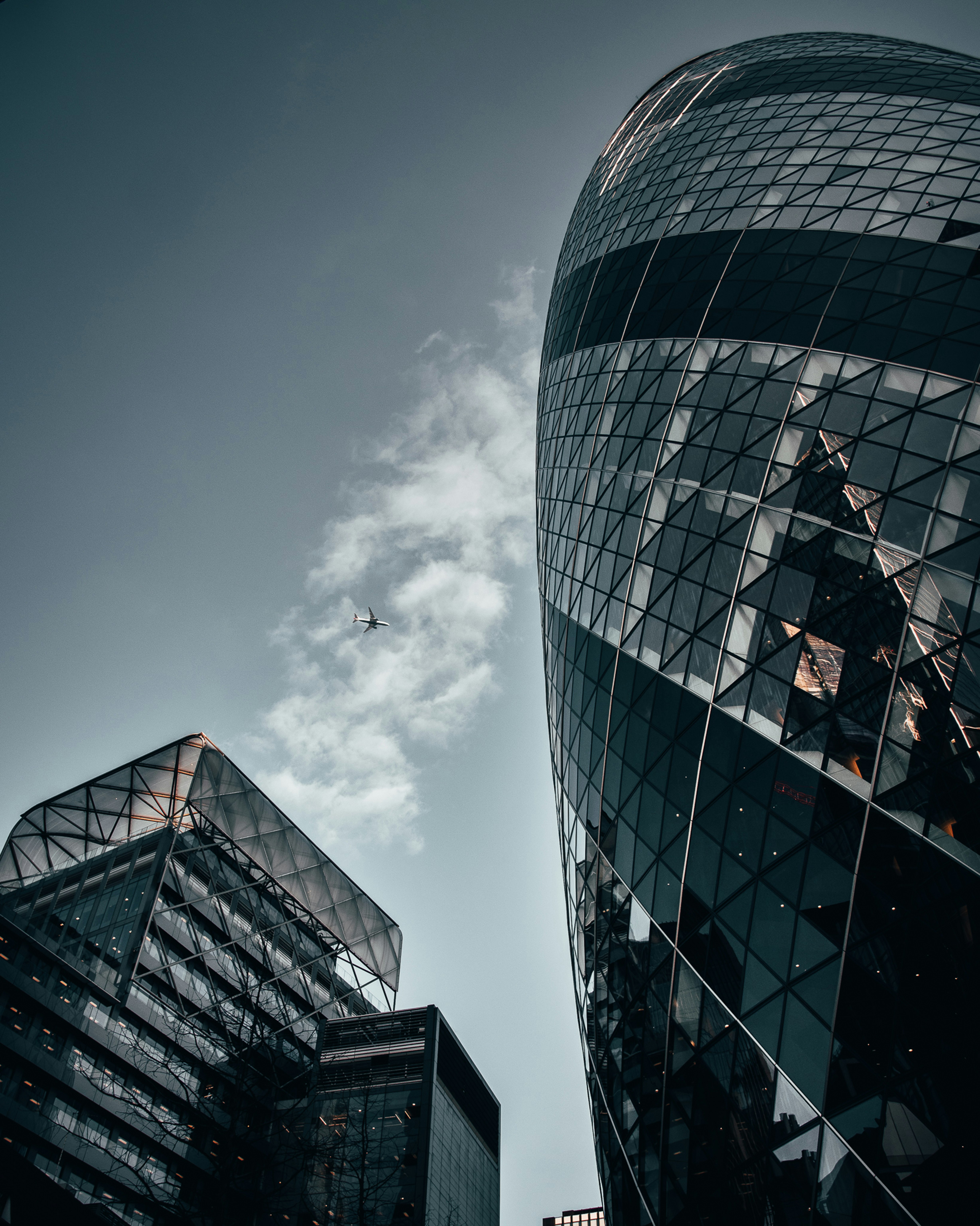 black and white concrete building under white clouds during daytime