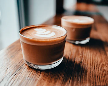 brown and white ceramic cup with cappuccino