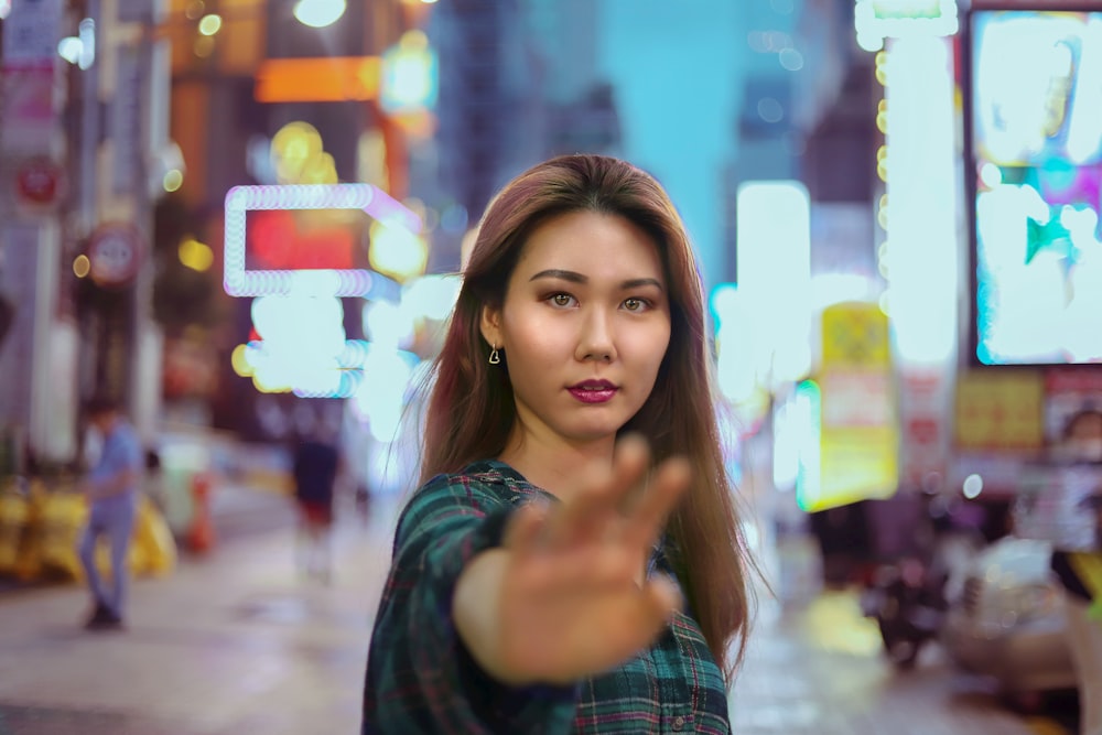 woman in blue and white plaid shirt smiling